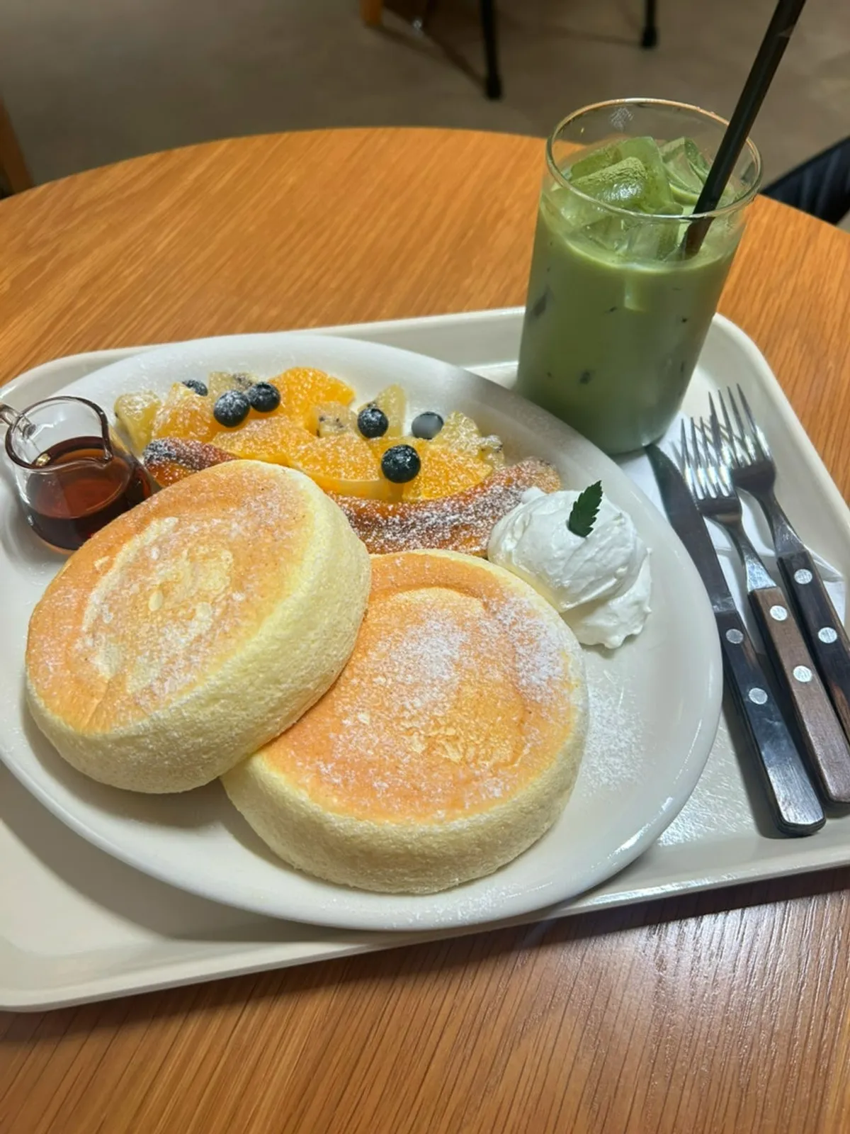 Petrico's menu board listing types of soufflé pancakes
