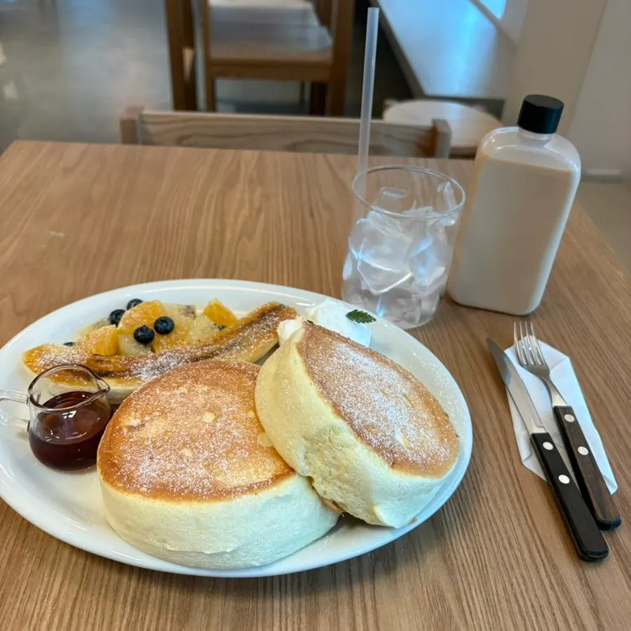 A thick fruit soufflé pancake cut with a fork
