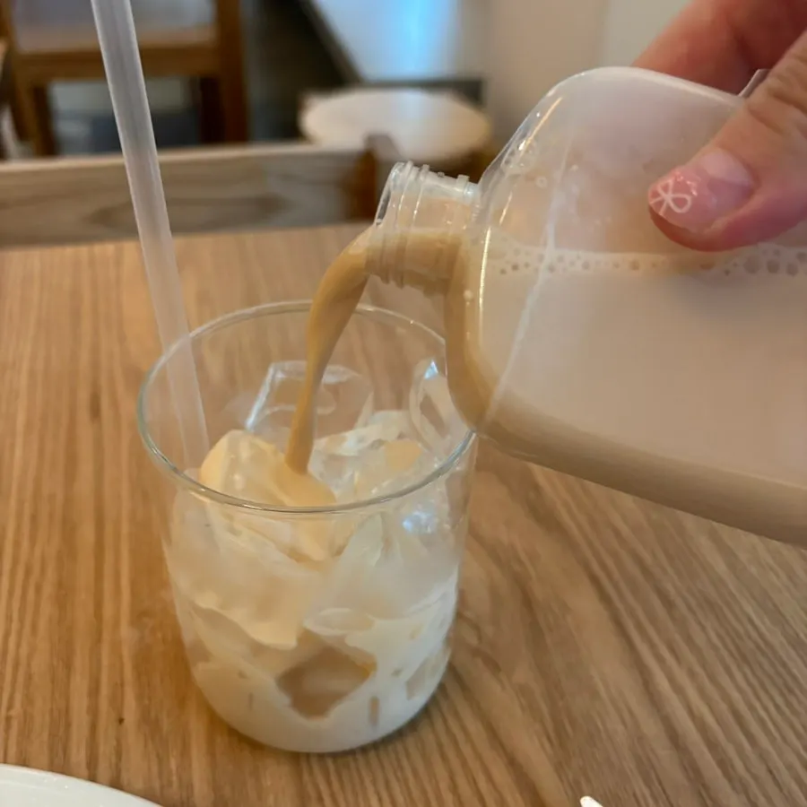 Table shot of milk tea served alongside the soufflé