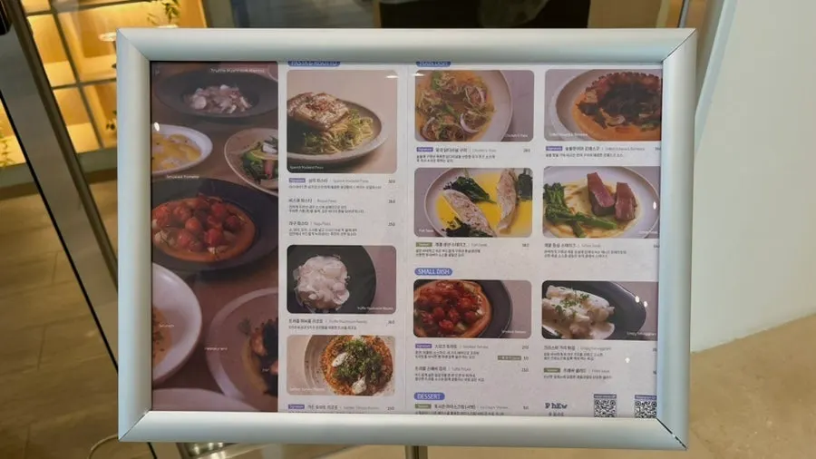 Menu board with photos set up outside the restaurant