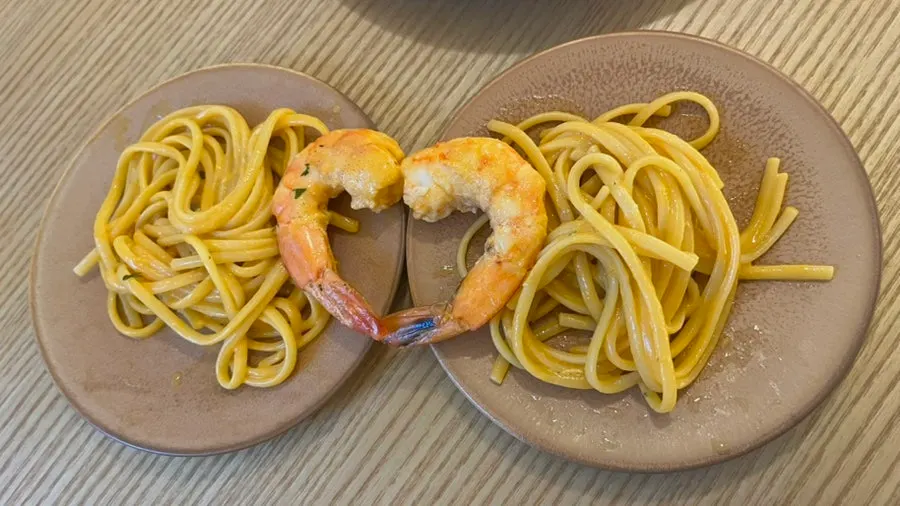 Shrimp arranged in a heart shape atop the pasta