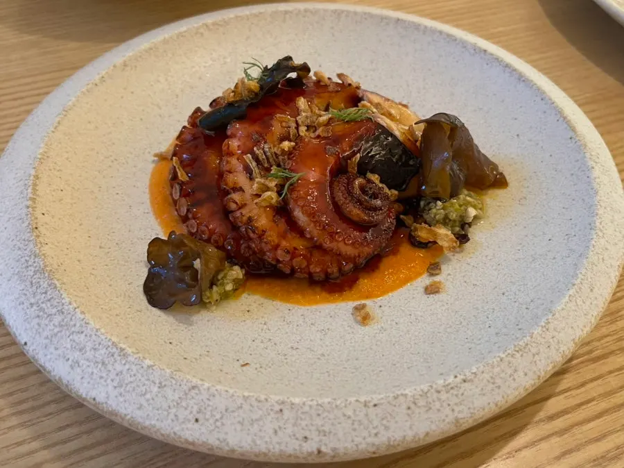 Signature charcoal-grilled octopus with romesco sauce