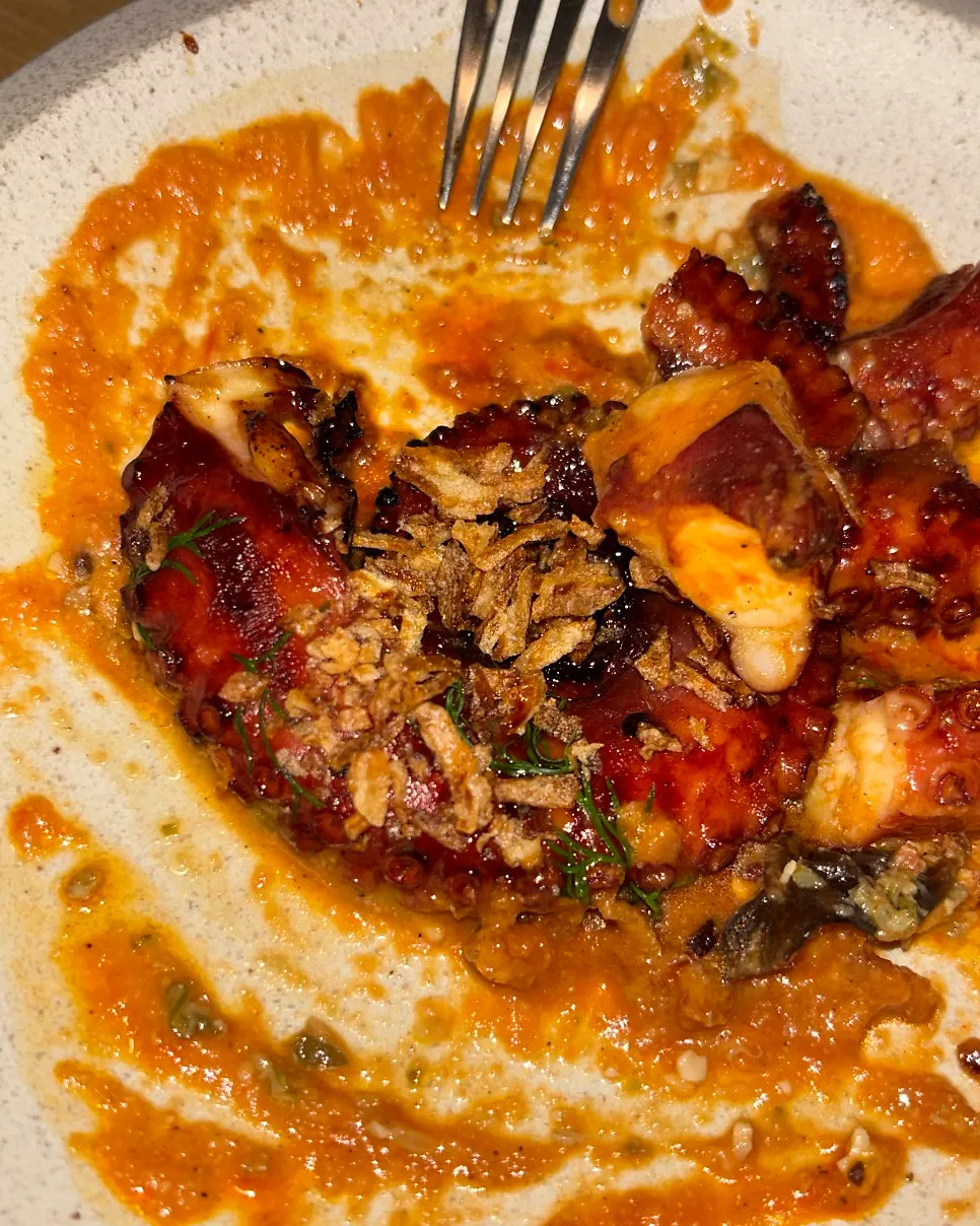Close-up of a tender piece of charcoal-grilled octopus