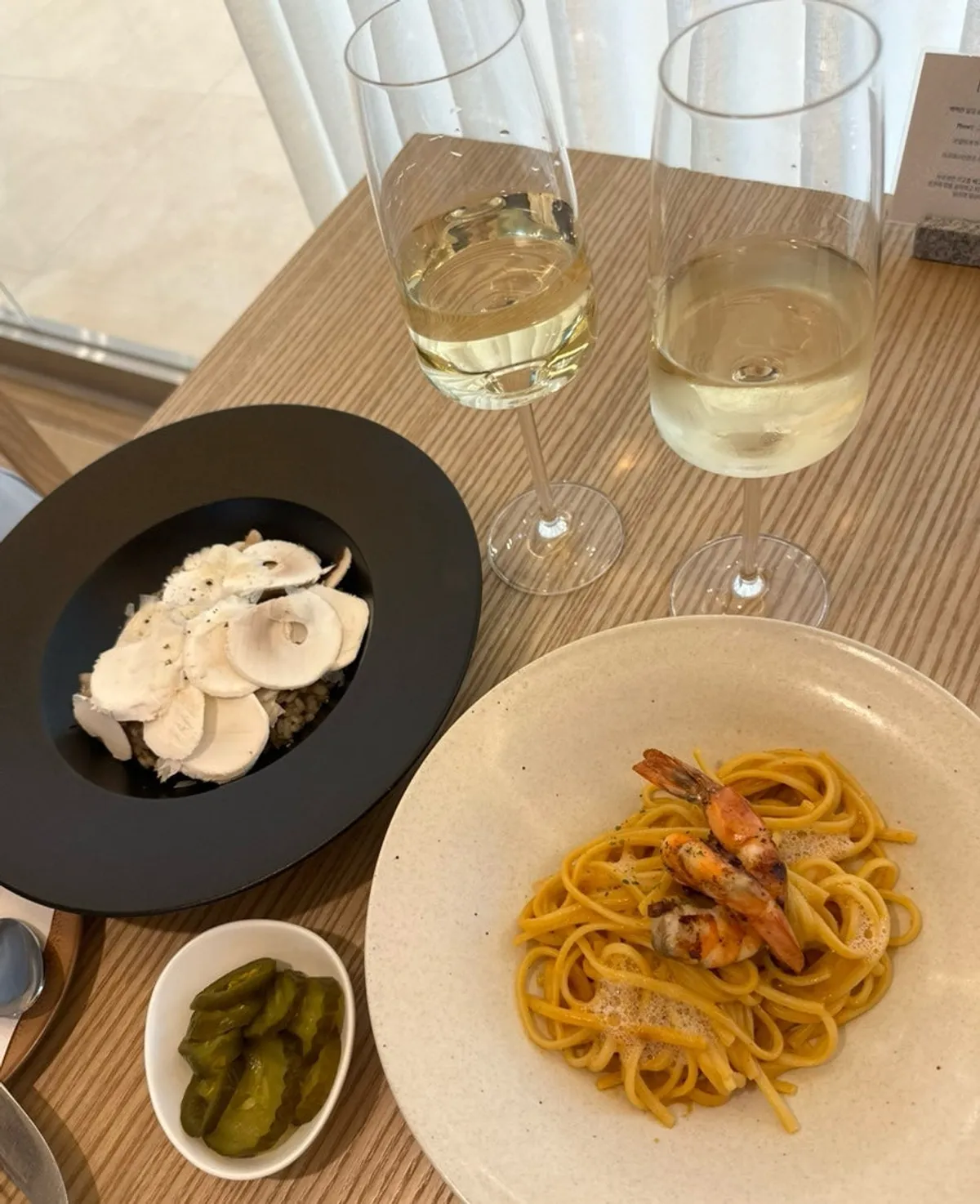 Table spread with pasta, risotto, and wine together