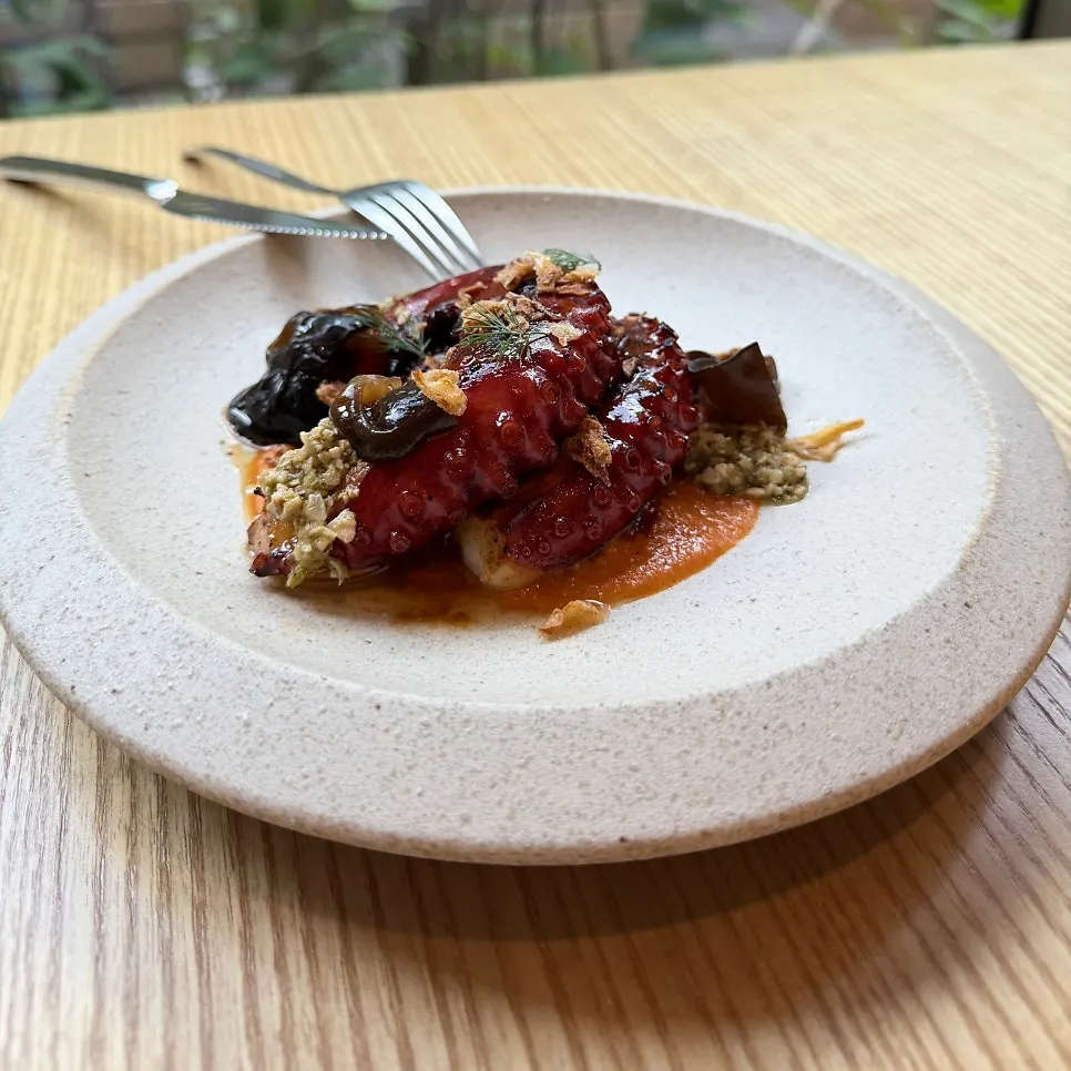 Plate of charcoal-grilled octopus with romesco