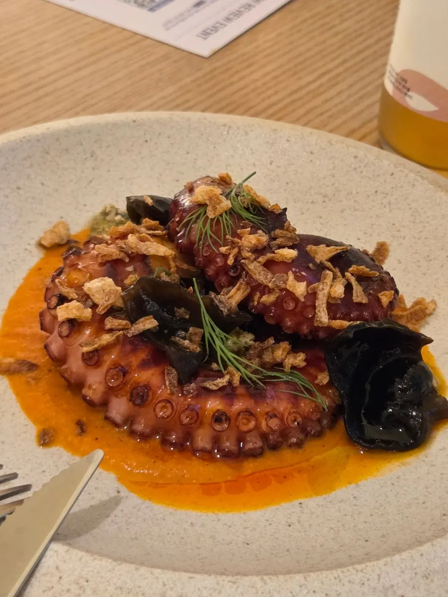 Charcoal-grilled octopus served with romesco sauce