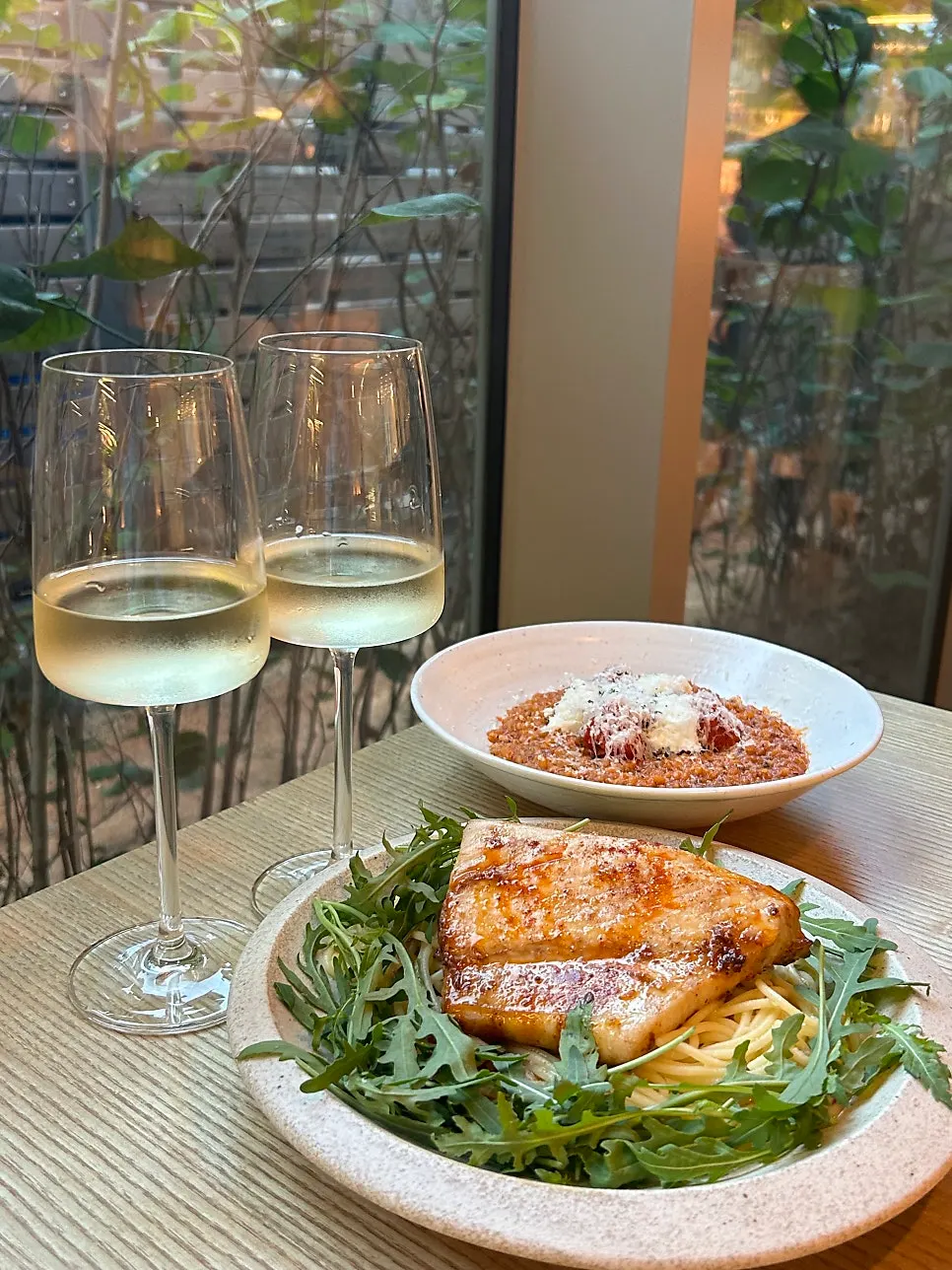 Table setting with mackerel pasta and tomato risotto