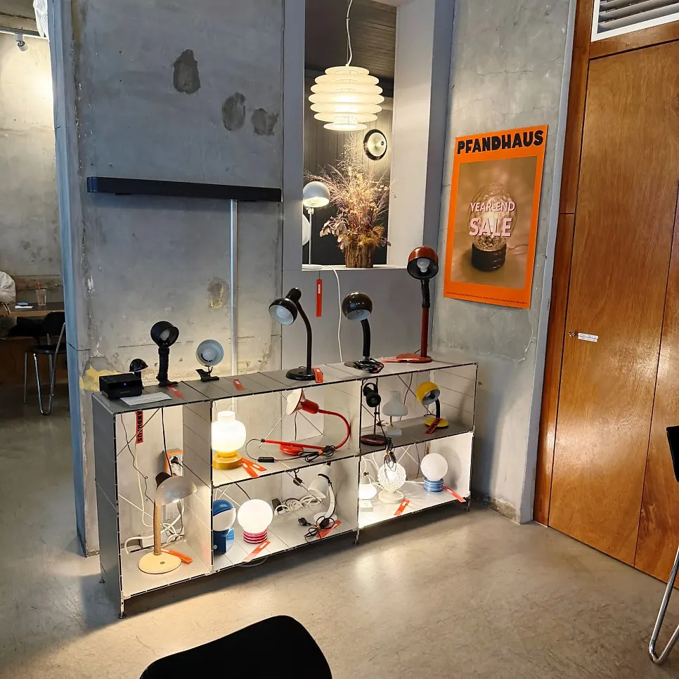 Lamps hanging from the ceiling and beside a table