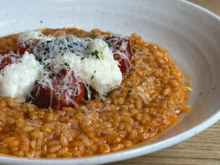 Tomato risotto topped with eggplant