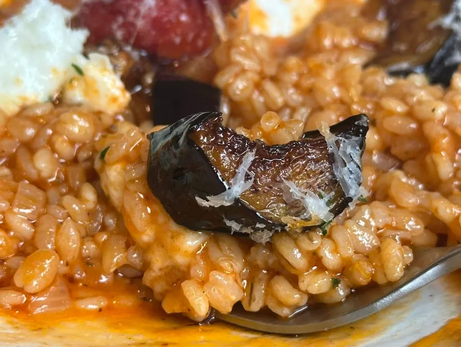 A spoonful of tomato risotto