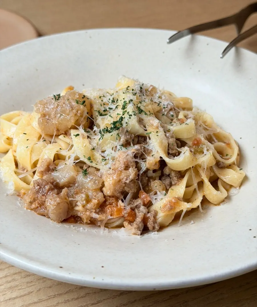 A plate of ragu pasta with beef tendon