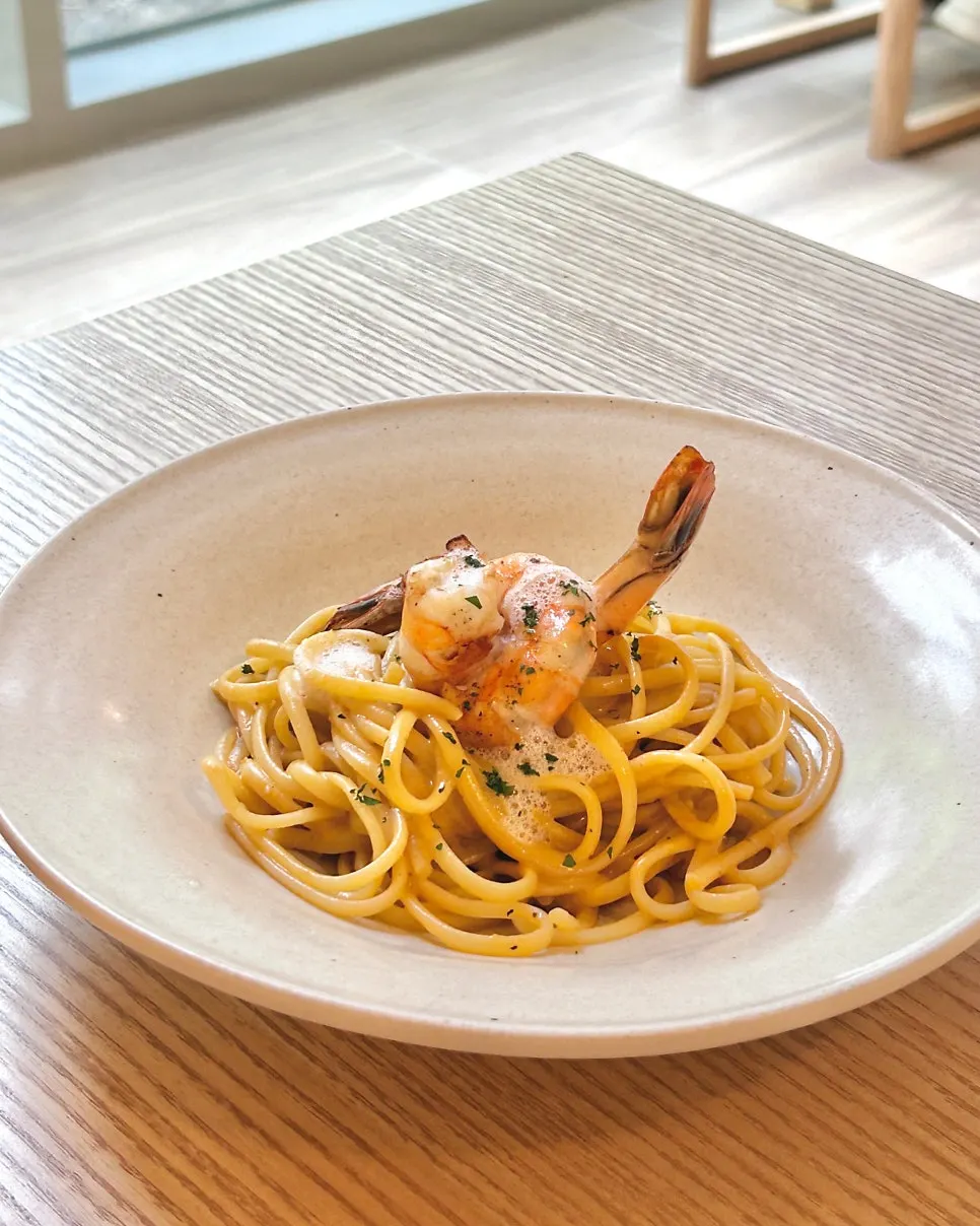 Bisque pasta topped with grilled shrimp