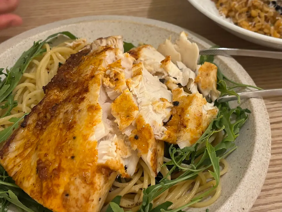 Mackerel pasta served alongside white wine