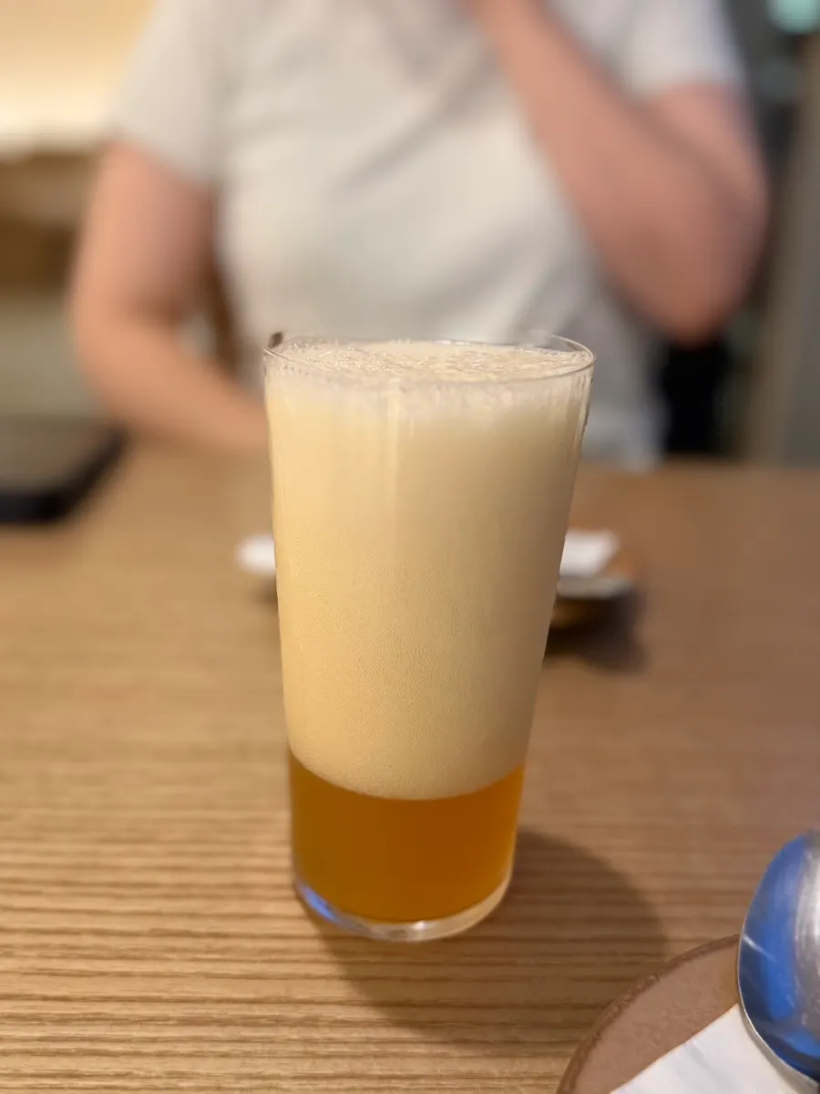 Glass of Cheongdam-dong Myeoneuri beer poured full of foam