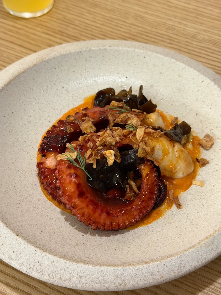 Whole charcoal-grilled octopus leg with romesco sauce