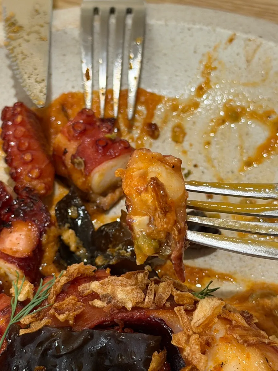 Charcoal octopus leg cut into bite-sized pieces