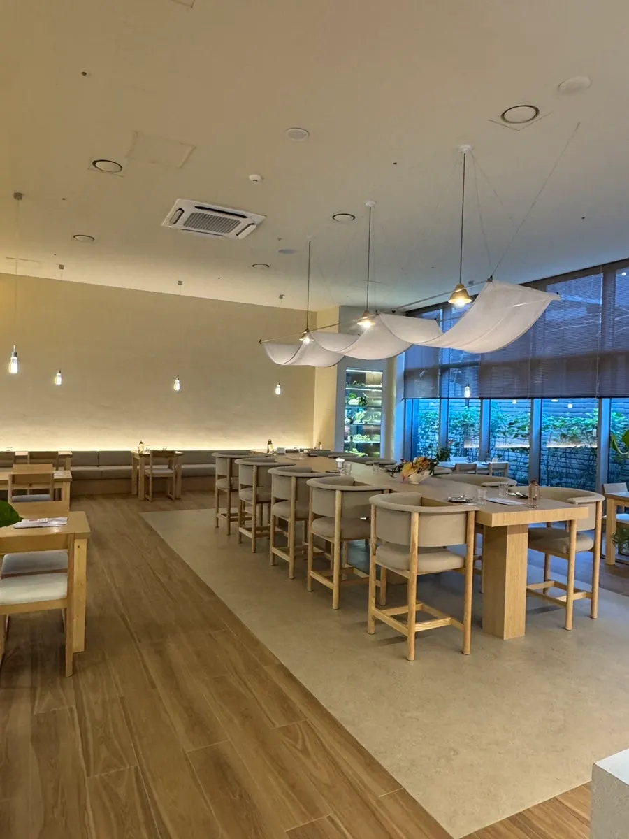 Wood-tone tables and beige-toned interior of Pyu Euljiro's hall