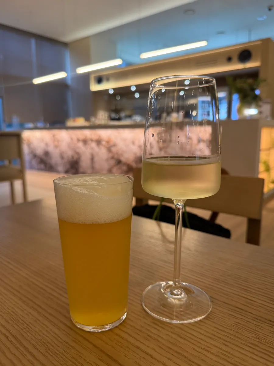 A glass of wine and a glass of beer served first