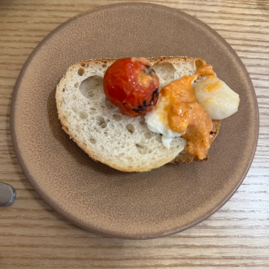 Tomato, cheese, and sauce piled onto bread