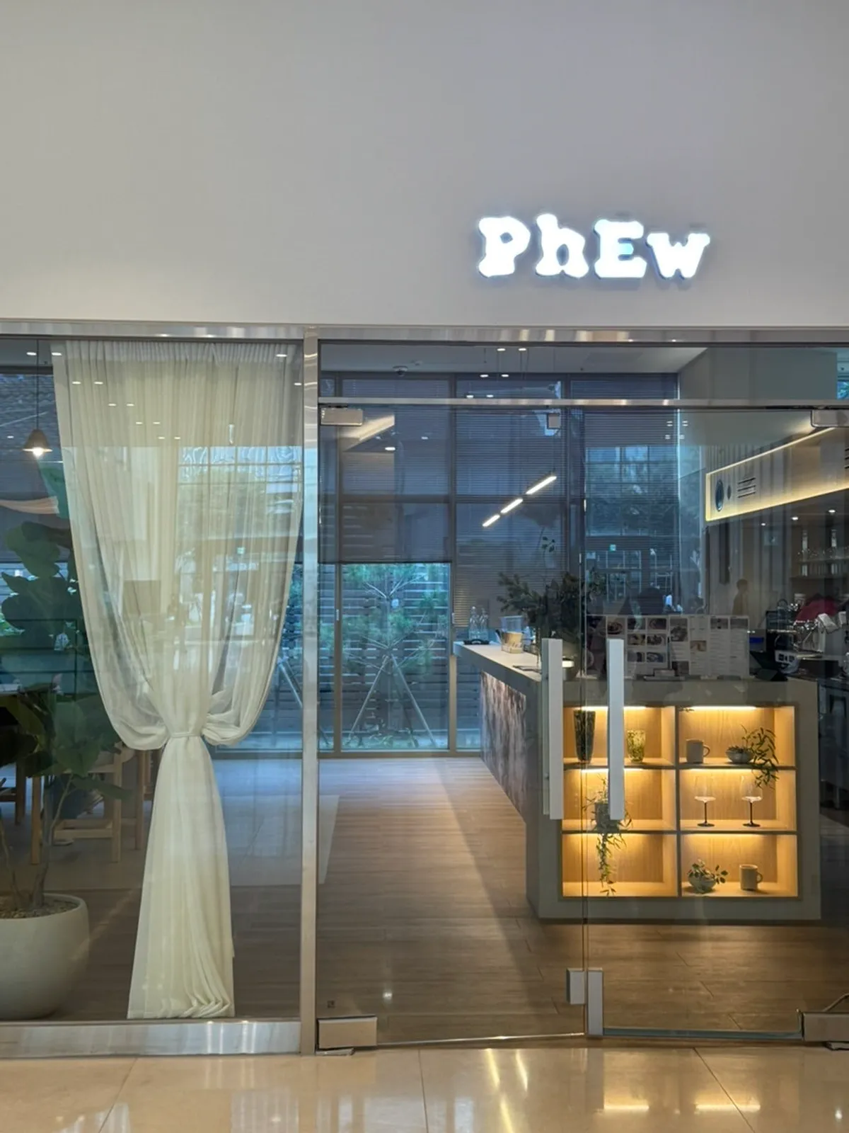 Exterior of Pyu Euljiro, a white-toned building with a lit-up sign
