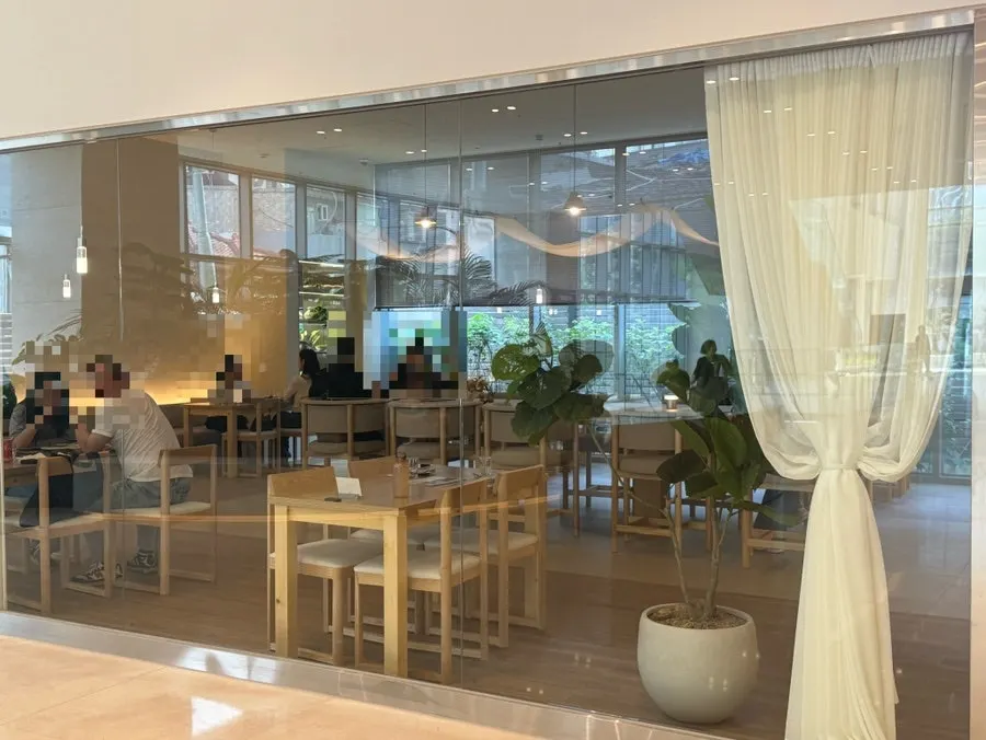 Floor-to-ceiling windows with ivory sheer curtains at Pyu Euljiro
