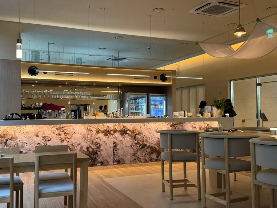 Marble-look bar counter with a wine glass display