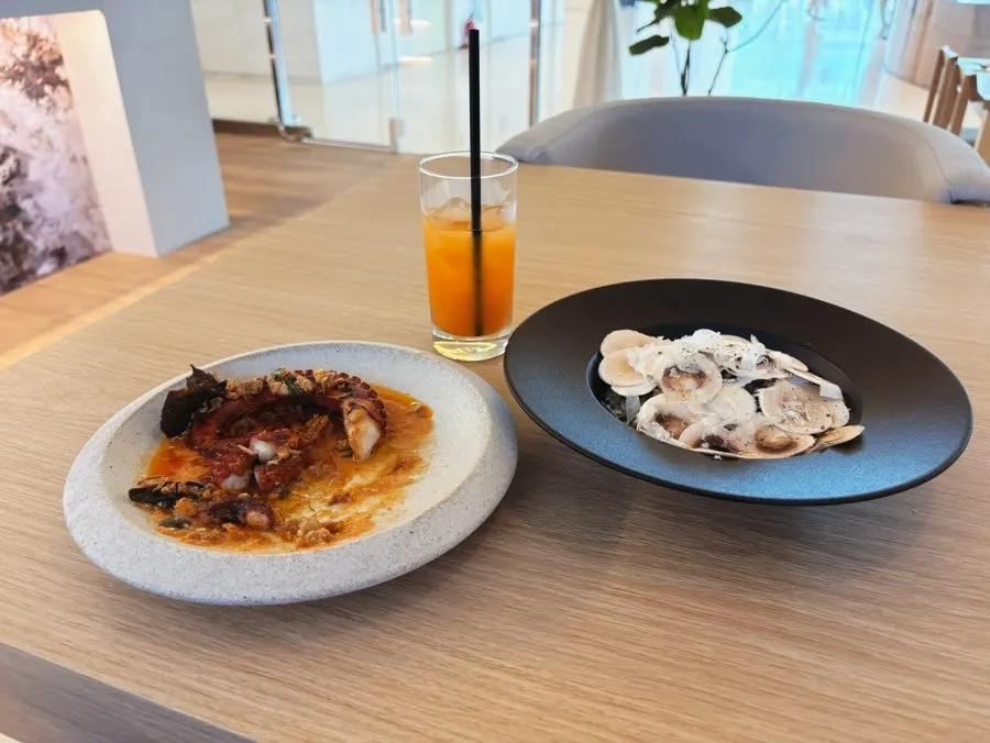Table with risotto and charcoal octopus together