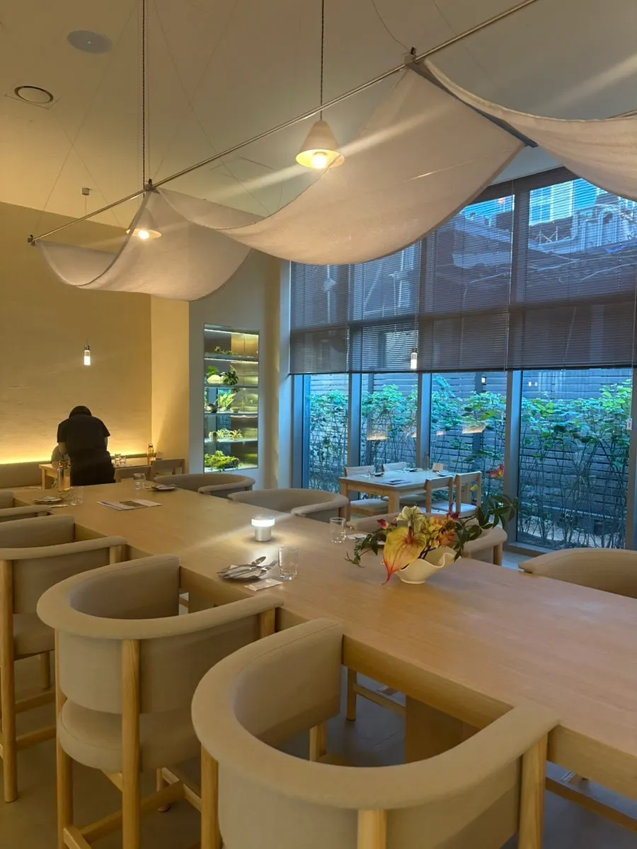 Hall interior with floor-to-ceiling windows and landscaping