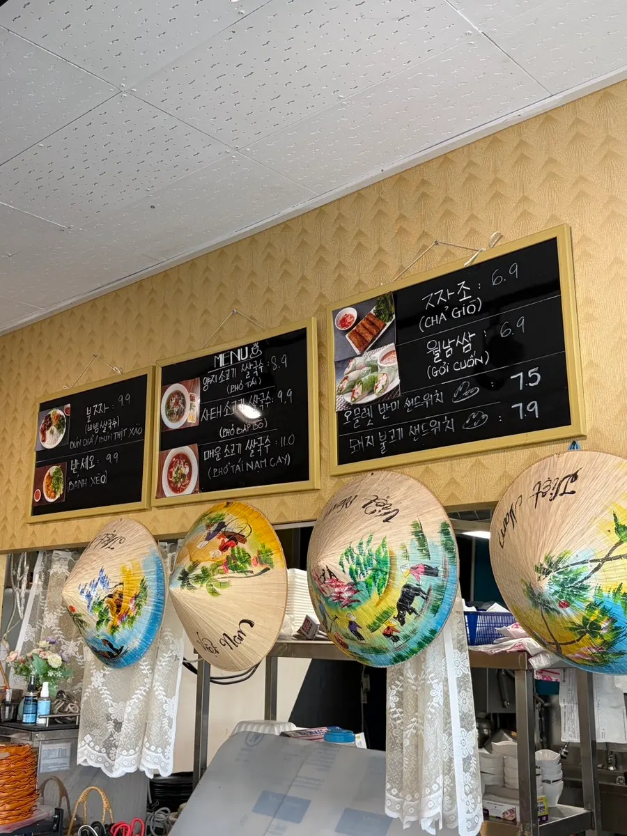 Phodam menu listing bun cha, banh xeo, and pho