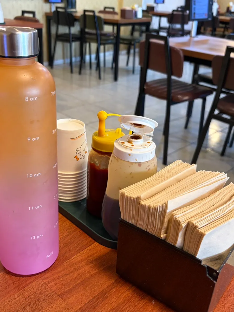 Table setting with two sauces and a bottle of water