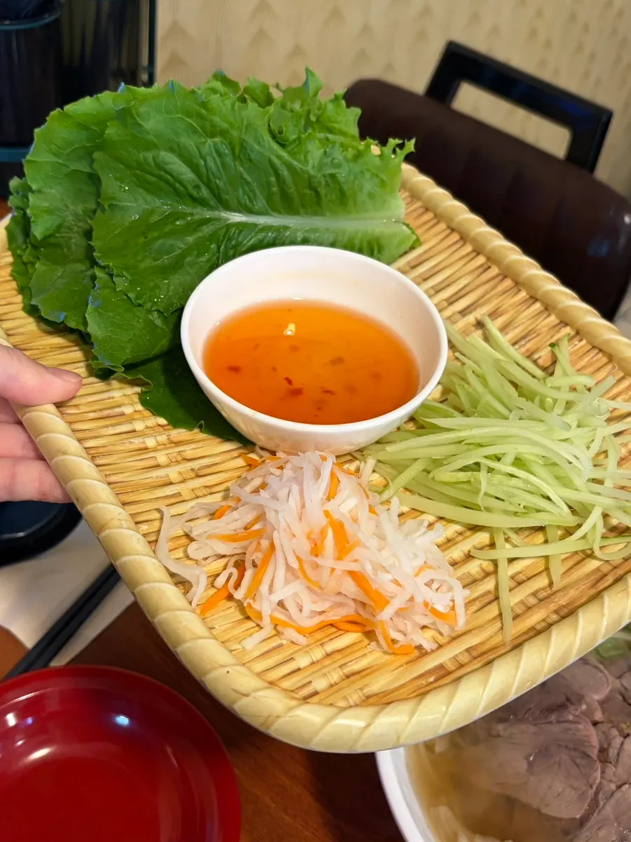Vegetables and rice paper served alongside the banh xeo