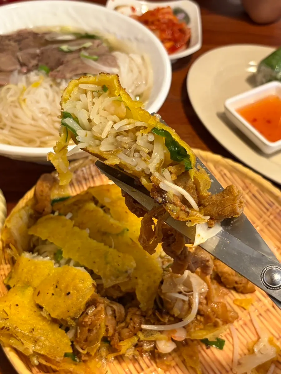 A bite of banh xeo wrapped in rice paper