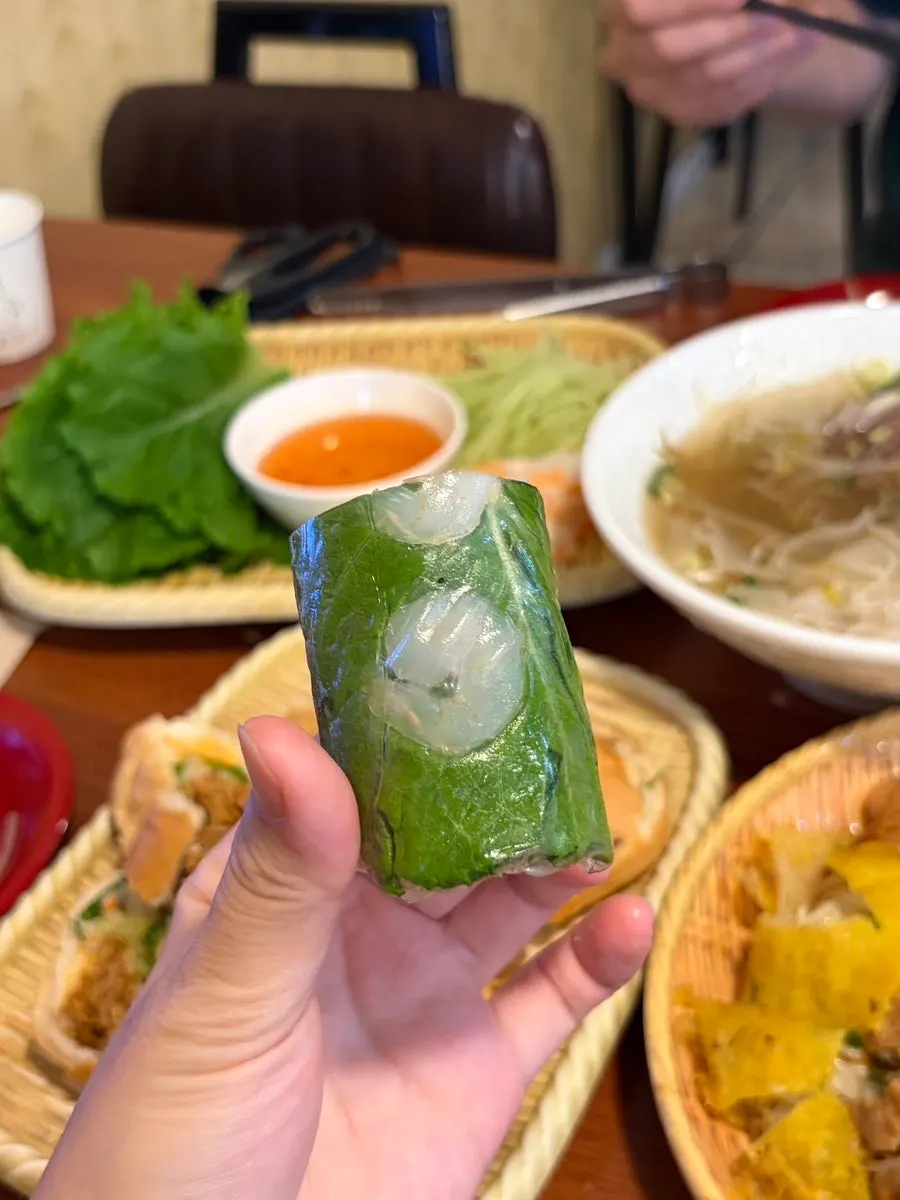 A bite-sized fresh spring roll dipped in sauce