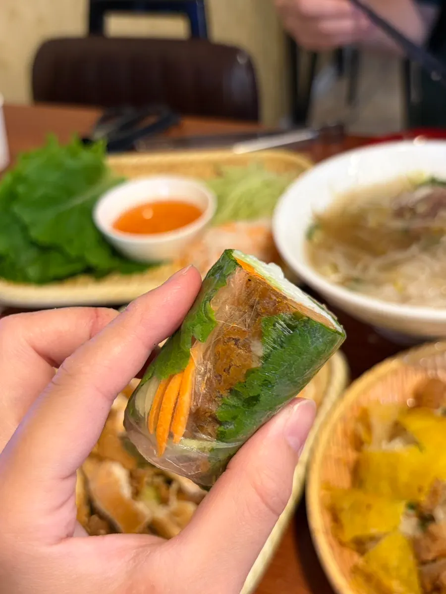 Close-up of meat and vegetables rolled inside a fresh spring roll