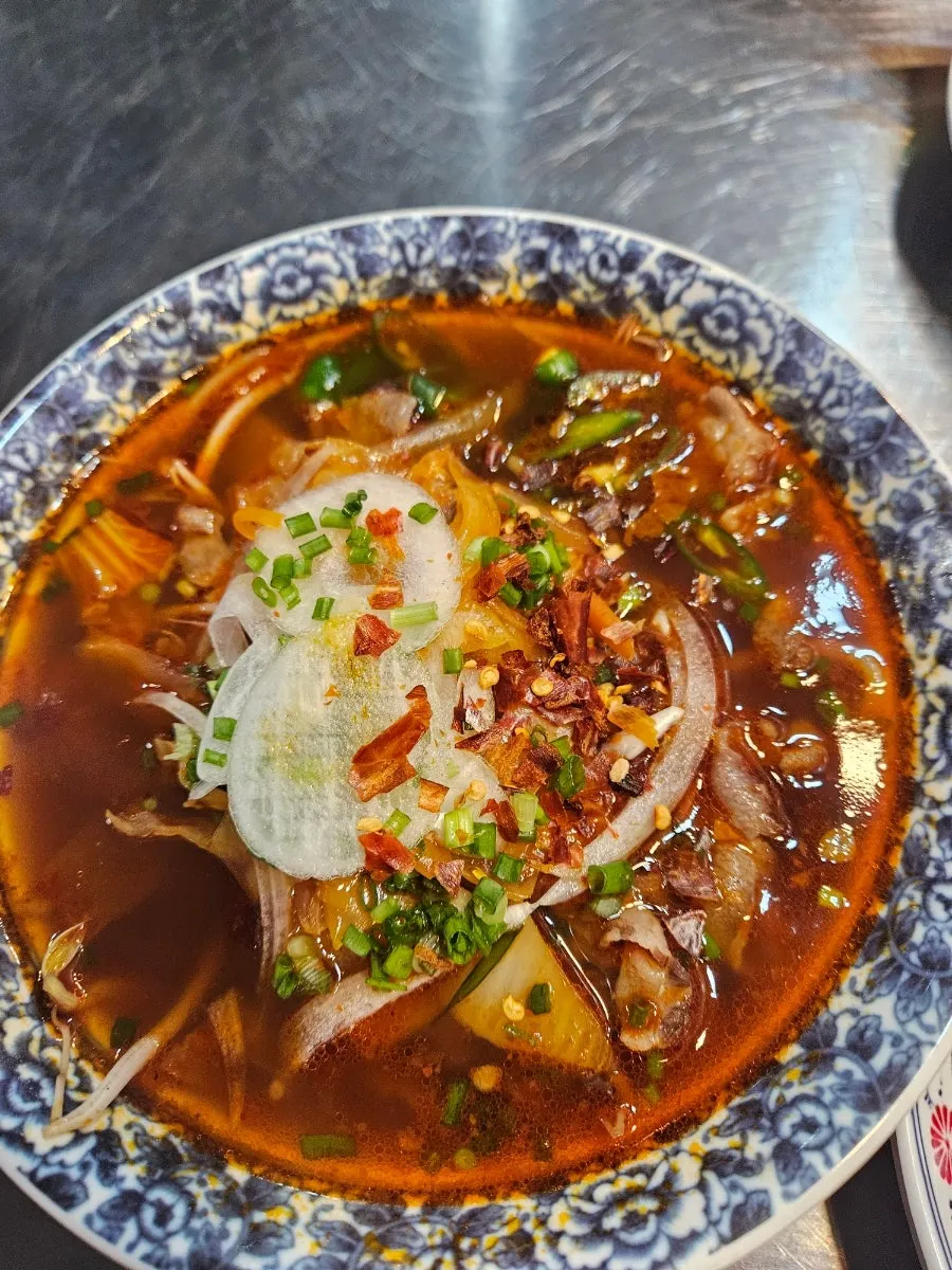 A bowl of sister-recommended spicy pho served as part of the set