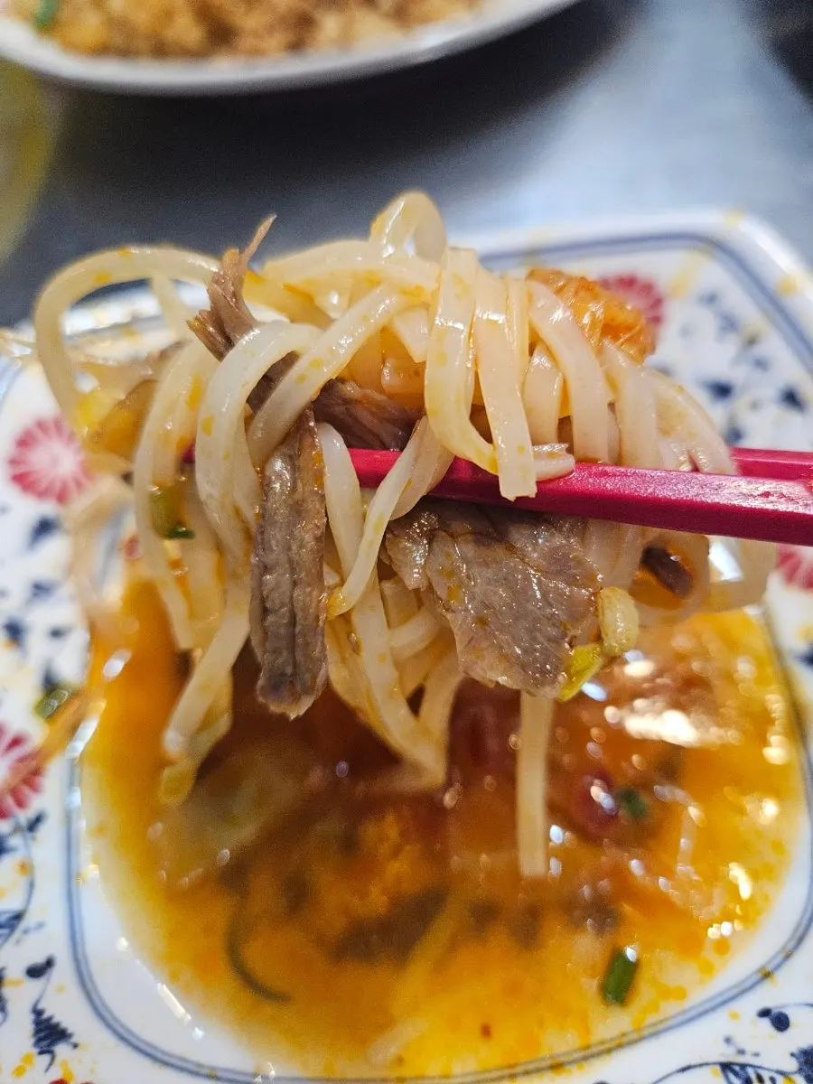 Pho meat dipped in chili sauce and hoisin sauce