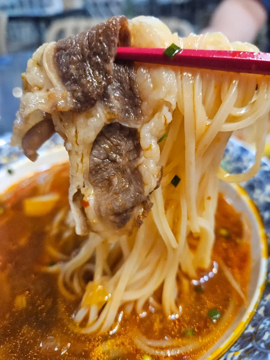 A bowl of spicy pho midway through the meal