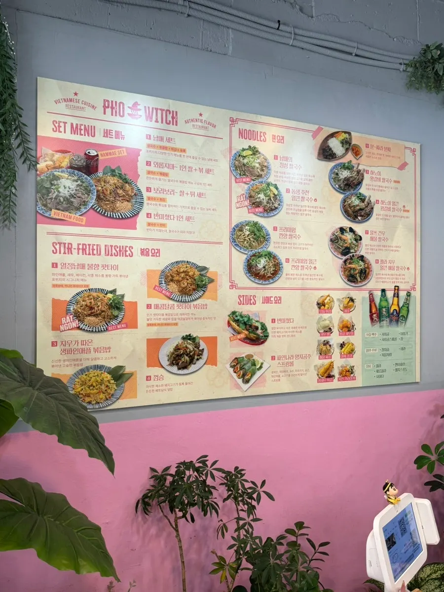 Pho Witch menu board with pho and stir-fried dishes