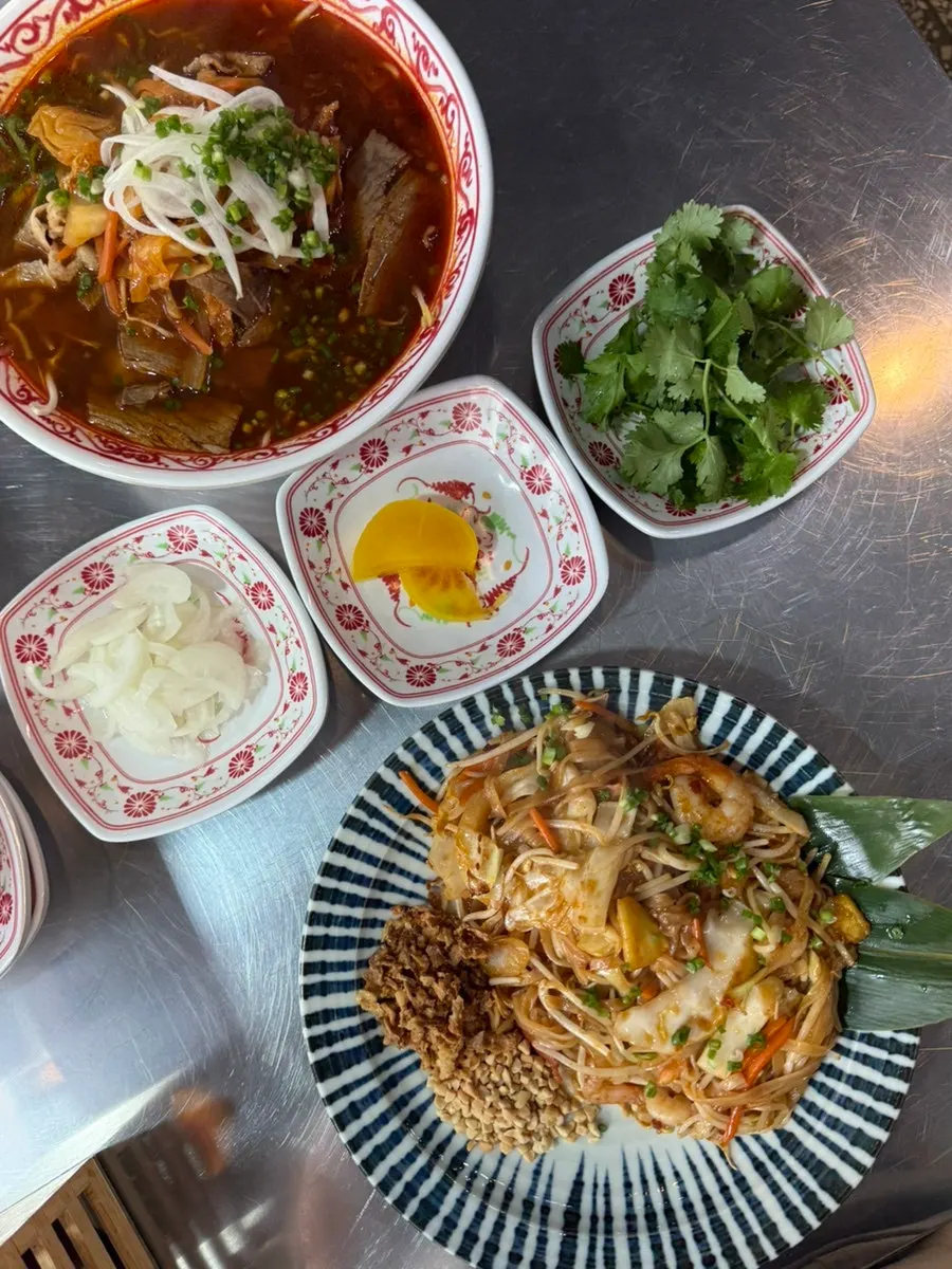 Basic side dishes of pickled onions and danmuji, plus added cilantro