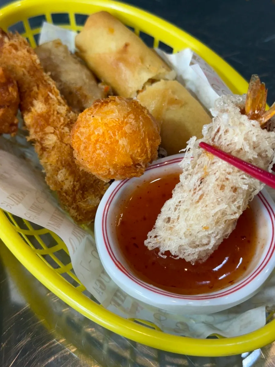 Fritter dipped in sweet chili sauce