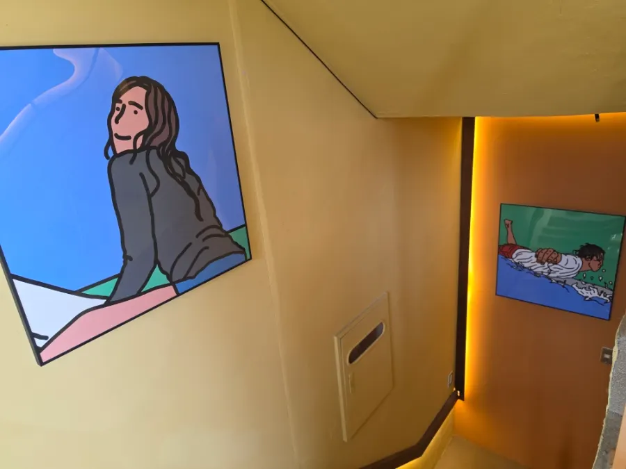 Staircase and wall to the 2nd floor decorated with surfer illustrations