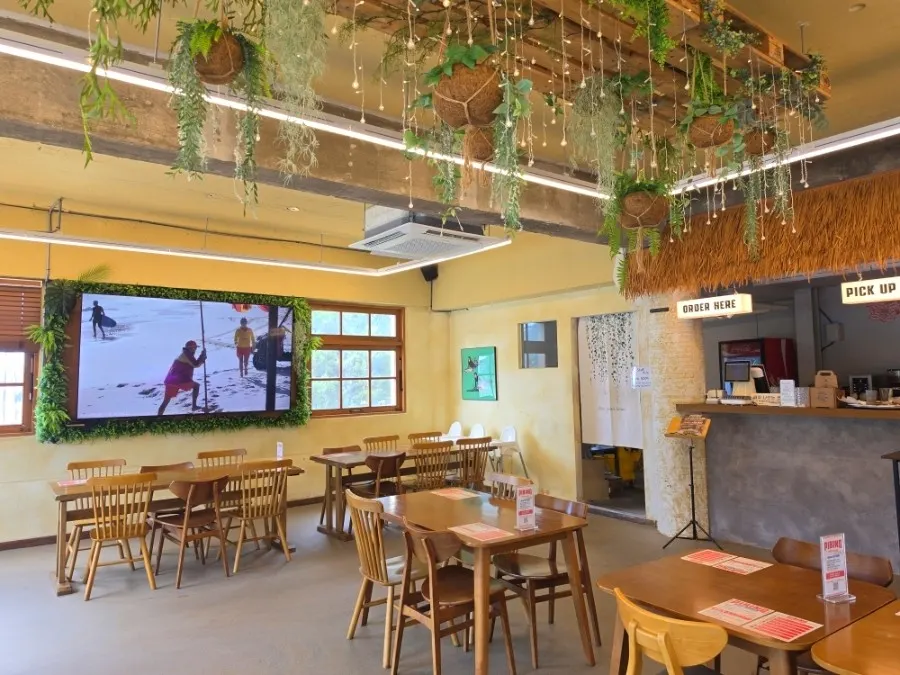 2nd floor space at Pibing with surfing footage playing