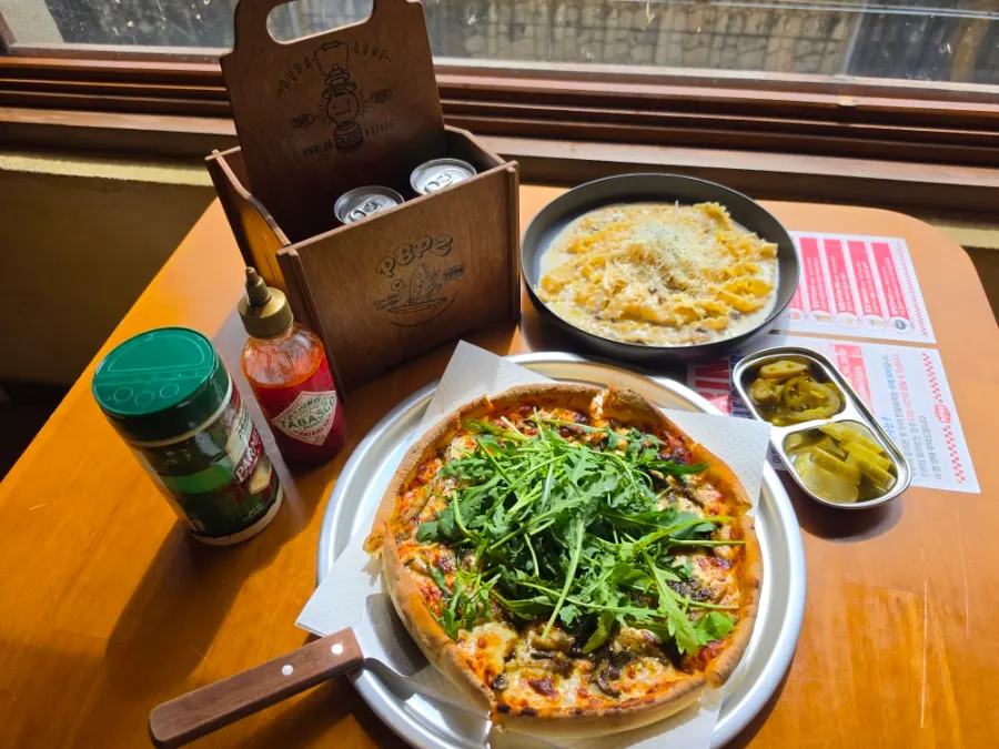 Surfer's pizza set on the table with a Han River view