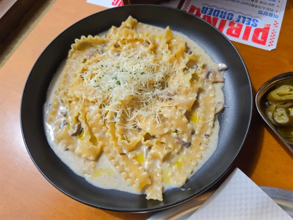 Truffle parmigiano cream pasta with wide, wavy noodles