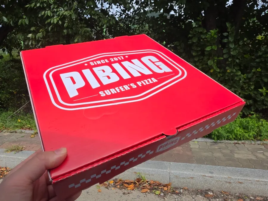 Takeout box packed with leftover pizza
