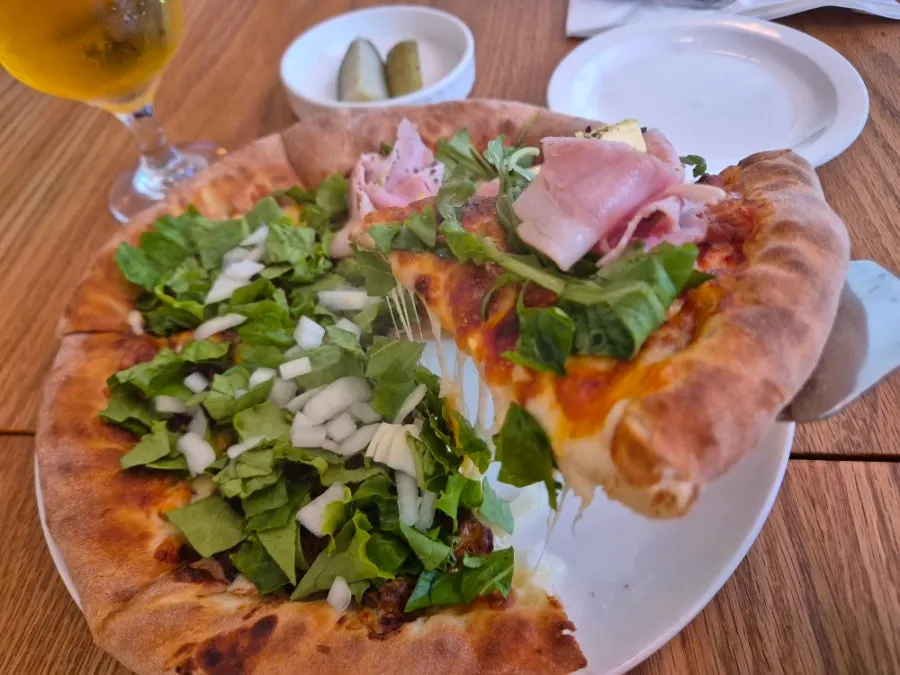 A slice served from the split pizza