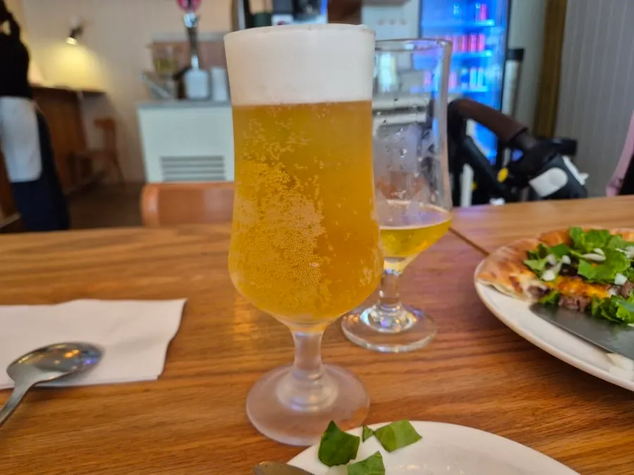 Pizza and draft beer on the table at Pickles