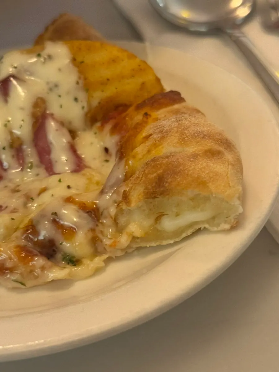 Potato pizza topped with wedge potatoes and bacon