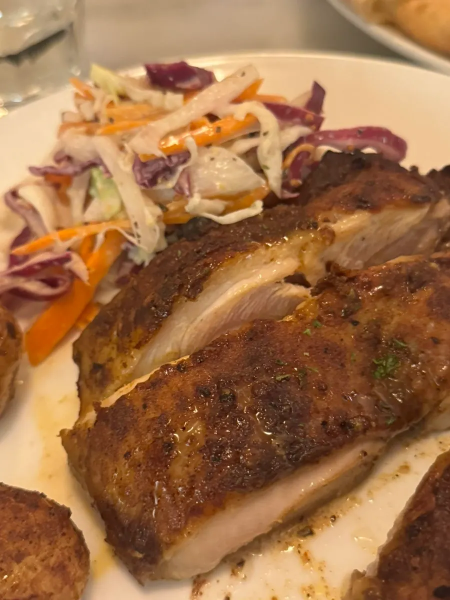 Chicken steak served with coleslaw and baby potatoes