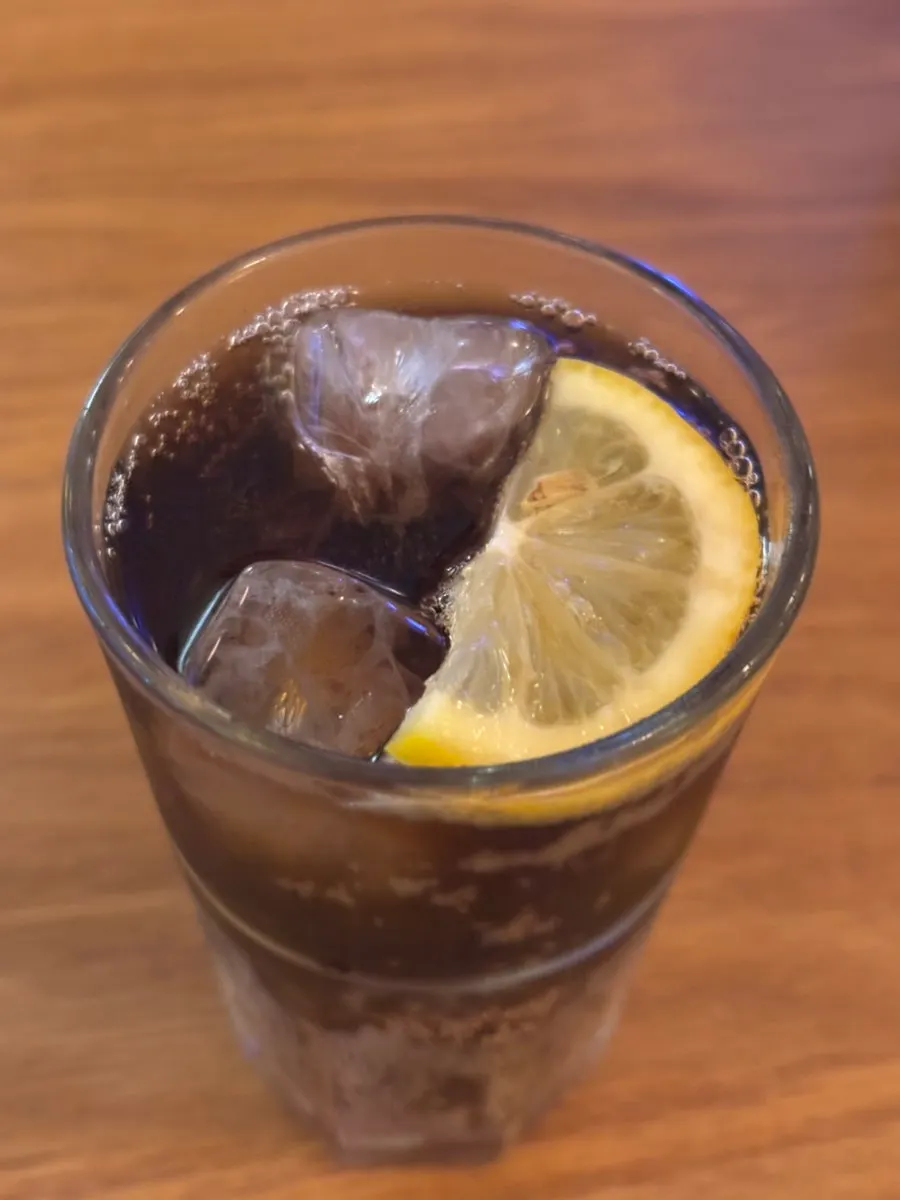 Soft drink poured into the lemon ice cup